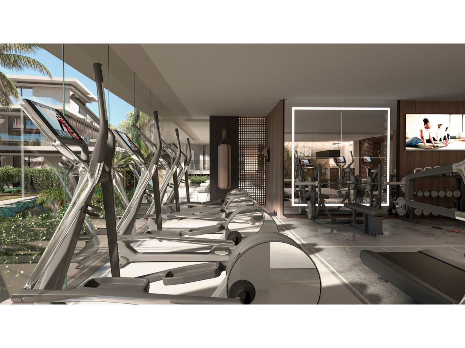 Modernes Fitnessstudio in einer Residenz mit Cardio- und Kraftgeräten.