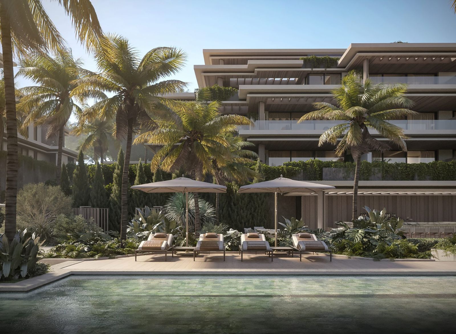 Luxuriöser Essence Residence Poolbereich mit Sonnenliegen und Palmen.